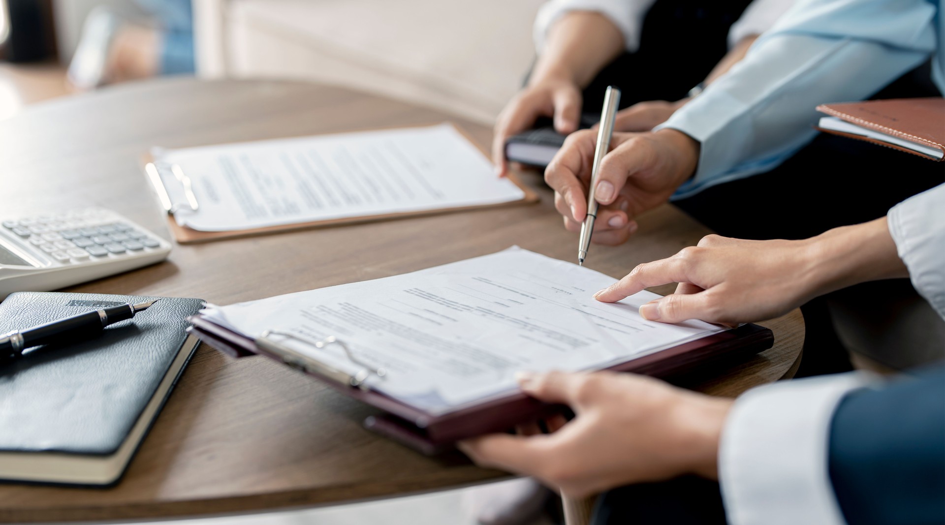 Real Estate Agent explain insurance and sign contract agreement contract to client.